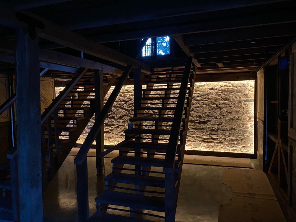 Insdie barn stairs with lights on wall